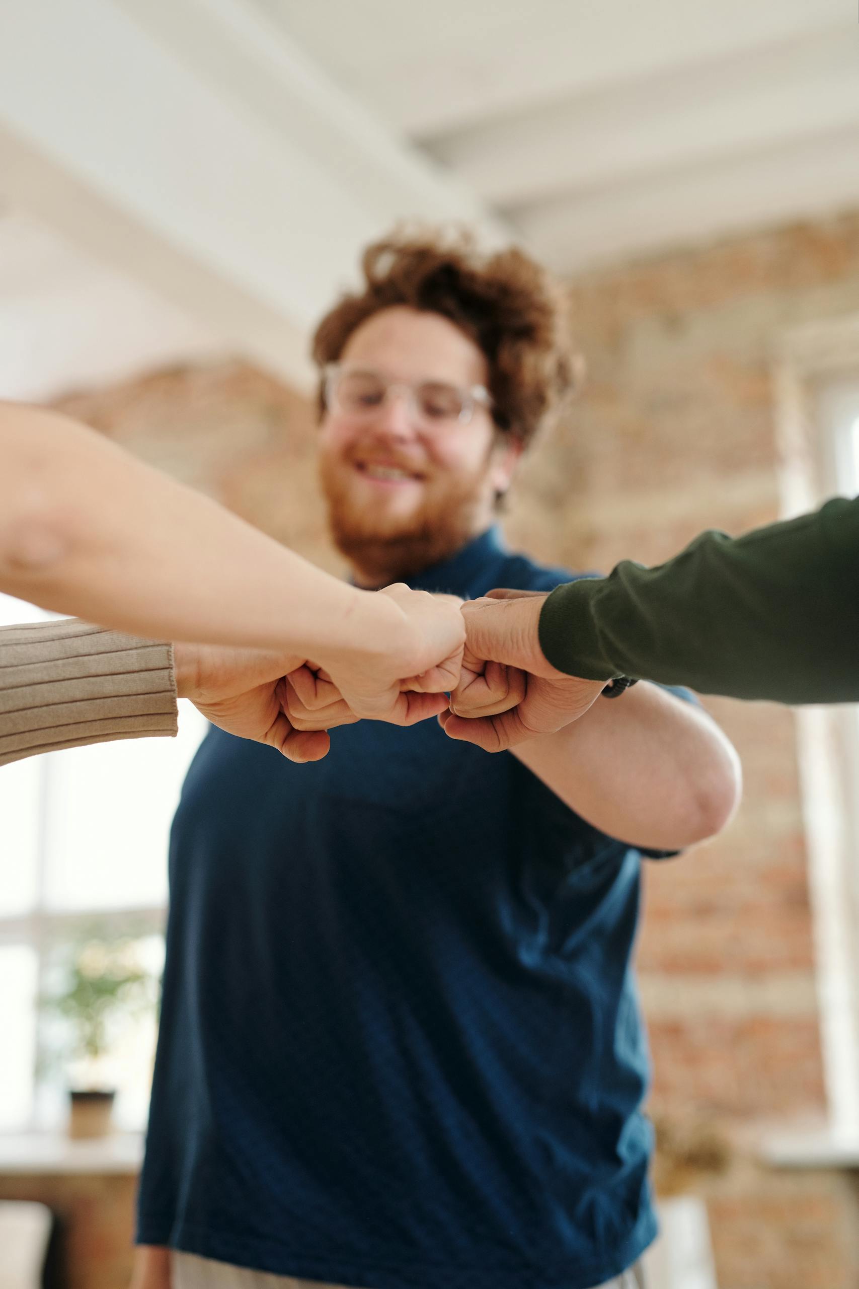 Man in Blue Shirt Doing a Fist Bump